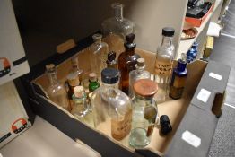 An assortment of pharmaceutical bottles and vials, approximately 18.