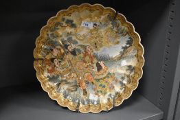 A 19th/20th Century Japanese Satsuma ware charger of scalloped outline, decorated with warriors,
