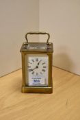 An early 20th Century French carriage clock, having brass four glass sided case and enamelled