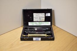 An early 20th Century Veterinarian's kit comprising syringe and other instruments, of ovine