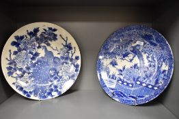 Two 19th Century Chinese blue and white chargers, both decorated to the centre with peacocks in