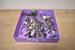 A large collection of hat pins of various size and design, including two silver examples, paste