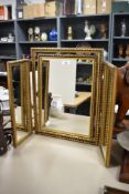 A mid-20th Century gilt wood triptych dressing table mirror, measuring 45cm high