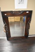 A 1940's oak framed mirror, with shaped, pierced and beaded detail to frame and bevelled plate