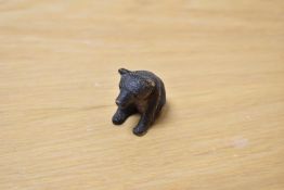 An early 20th Century Black Forest style crouching bear, measuring 3cm high