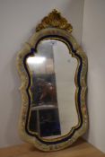 A mid-20th Century Continental wall mirror, of shaped outline with a floral hand painted frame