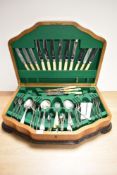 An Art Deco walnut cutlery canteen, containing an assorted collection of silver plated cutlery by