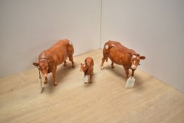 A Border Fine Arts Pottery Company Limousin Cow family, comprising Bull A4578, Cow A4581 and Calf