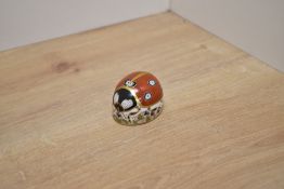 A Royal Crown Derby bone china Ladybird paperweight, decorated with a gilt enriched stylised Imari