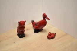 Three Royal Doulton fine bone china Flambe glazed figures comprising Duck HN807, Seated Cat HN109 (
