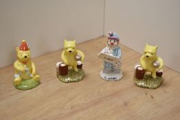 A group of three Royal Doulton bone china Disney Winnie The Pooh figures, Pooh Counting The Honey
