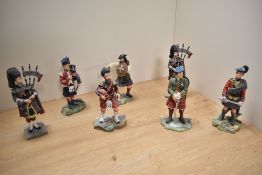 A group of seven 'Sculptures UK Scotish Higlander military figues, including three pipers 17cm