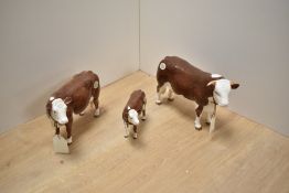 A Border Fine Arts Pottery Company Hereford Cow family, comprising Bull A4578, Cow A4583 and Calf