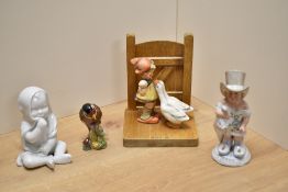 A Hummel/Goebel porcelain and wooden bookend, goose girl, marked M.J Hummel along with V mark to