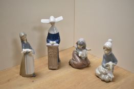 A group of four Lladro porcelain figurines, comprising shepherd boy with lamb, shepherd girl with