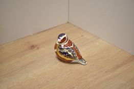 A Royal Crown Derby bone china Chaffinch paperweight, decorated in a stylised Imari design