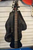 A 5 string electric bass guitar, headstock stamped Manhattan, with soft gig bag