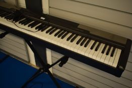 A Casio CDP-100 digital piano and stand