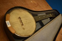A traditional banjolele with case