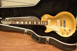 A 2001 Gibson Les Paul Gold Top, P90 pickups, Left Handed, serial number 116411415, in CNB hard