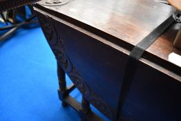 A late 19th or early 20th Century gate leg dining table having lunette carved decoration