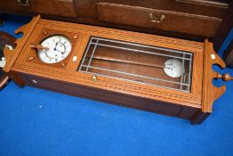 A modern golden oak cased wall clock
