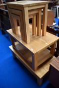 Two modern beech effect coffee tables and a similar nest of three tables