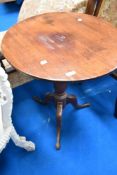 A 19th Century mahogany pedestal occasional table having circular top on turned column and triple