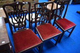 A set of three Chippendale style dining chairs having drop in seats and H stretchers