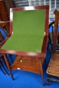 An early 20th Century mahogany fold over card table with undershelf