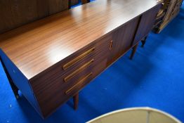A vintage laminate sideboard of stylised form, width approx. 163cm