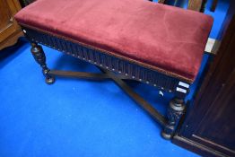 A late 19th or early 20th Century oak framed duet piano stool