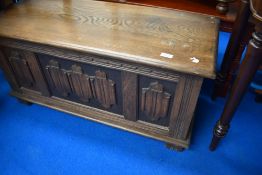 A Priory style oak blanket box having linen fold decoration, dimensions approx. 95 x 46 x 40cm