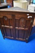 A traditional oak corner wall cupboard, having rosette carving decoration, width approx 96cm, height