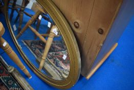 A gilt frame wall mirror of oval form (af)