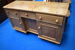 A natural pine sideboard having recessed centre , width approx. 132cm