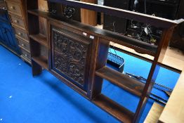 A 19th Century oak plate rack having carved panel door to centre cupboard