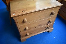 A modern pine three drawer chest