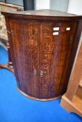 A 19th Century oak bow fronted corner cupboard