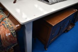 A modern shop display table, white powder coated, approx. 243 x 121cm