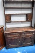 A 19th Century Jacobean style oak dresser having open delft rack, width approx. 122cm