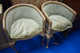 A pair of early to mid 20th Century walnut tub chairs having green dralon upholstery