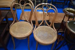 Two traditional bentwood chairs having cane seats
