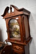 A reproduction long cased clock having stained case and brass dial