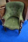 A Victorian scroll arm easy chair having button back