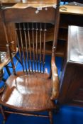 A traditional oak spindle back rocking chair