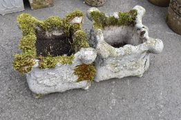 Two concrete garden planters having shaped edge