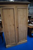 A traditional stripped pine wardrobe, dimensions approx. H206 W130 D56cm
