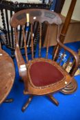 An early to mid 20th Century oak revolving office chair