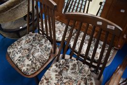 A set of four dark stained Ercol spindle back kitchen chairs